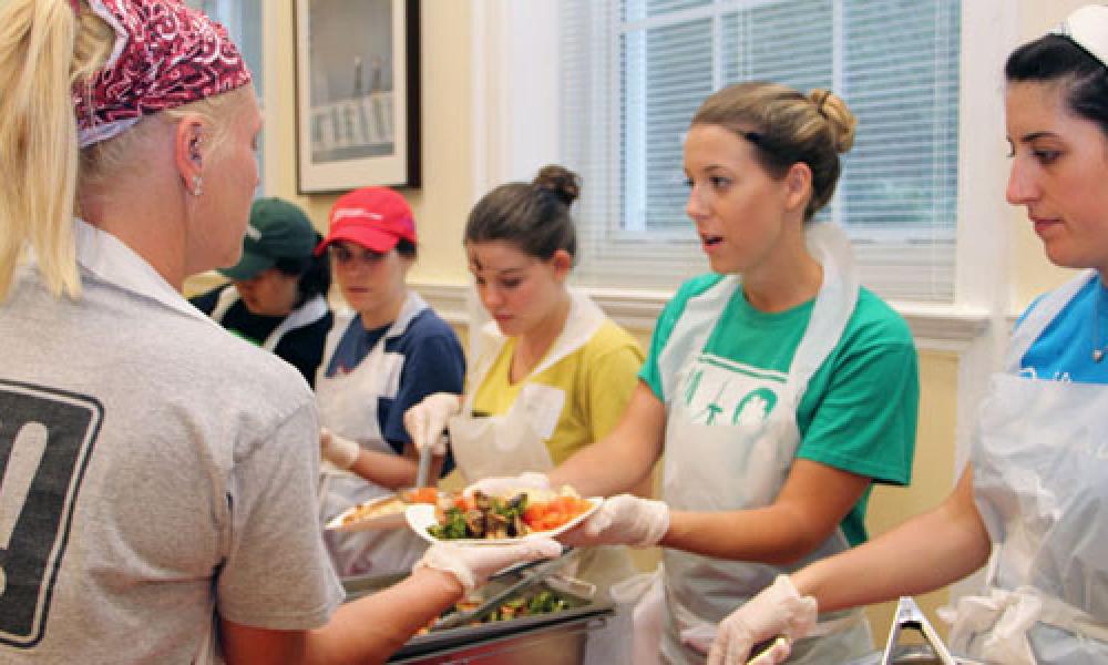 Image of college students handling food